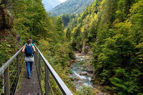 Hiking Group On Spectacular Trail Triftsteig Through Canyon Tiefenbachklamm With Brandenburger Ache In Tyrol, Austria