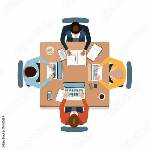 Overhead view of a team collaborating around a wooden desk with laptops and paperwork in a neutral-colored setting.