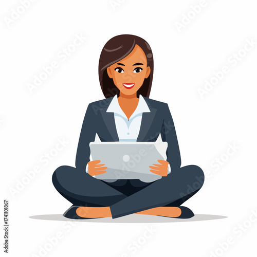 A smiling young businesswoman sits cross-legged on the floor holding a laptop in a professional outfit against a clean white background.