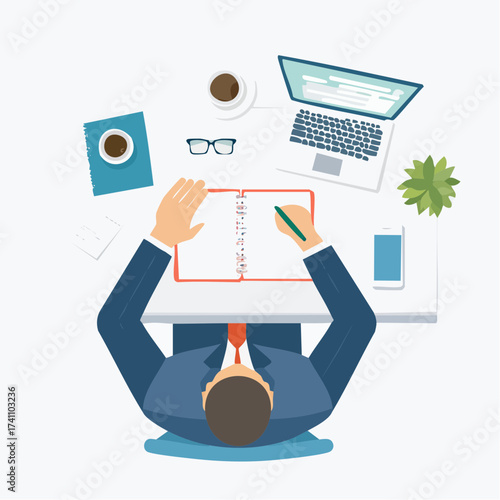 Overhead view of a businessman sitting at a desk writing in a notebook with a laptop coffee cup and glasses nearby on a white background.
