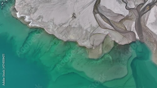 A quadcopter view of Lake Issyk (Almaty Region, Kazakhstan) and the mountain river flowing into it on an autumn morning.