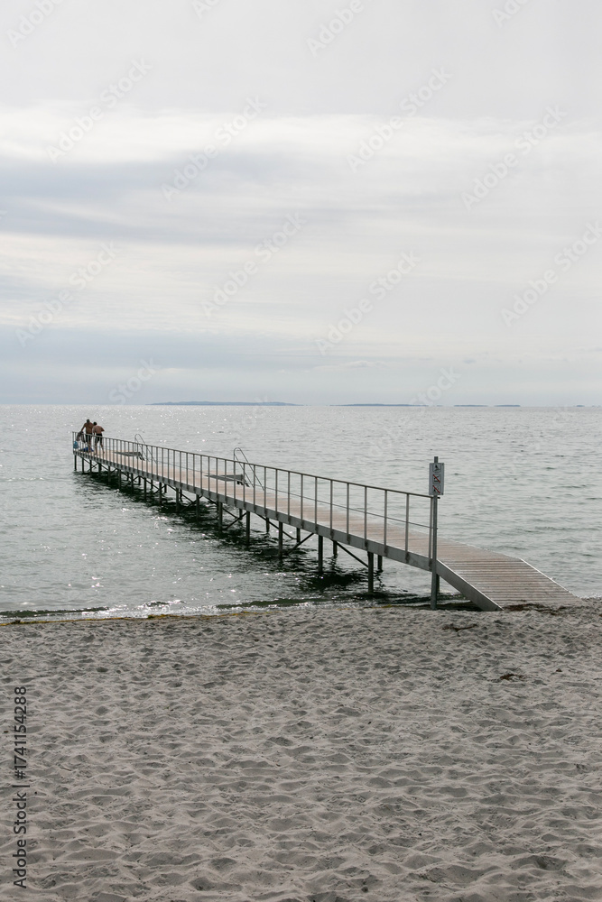 Obraz premium Wooden bathing walkway on the Baltic Sea beach in Denmark.
