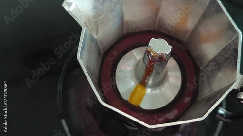Close-up of fresh coffee bubbling inside a Moka pot