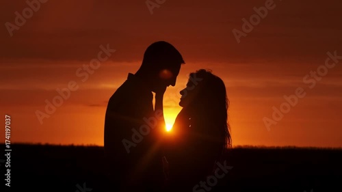 Silhouette of a couple in love in a romantic setting at sunset. Concept love story. Super slow-motion shot.