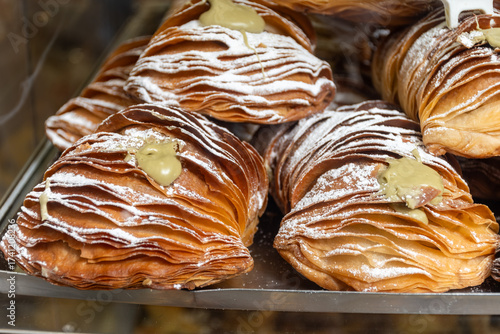 Italian desssert, Naples dessert with pistachio sfogliatella, shell-shaped layered pastry, with sweet custard-like filling made with semolina, ricotta, pistachio