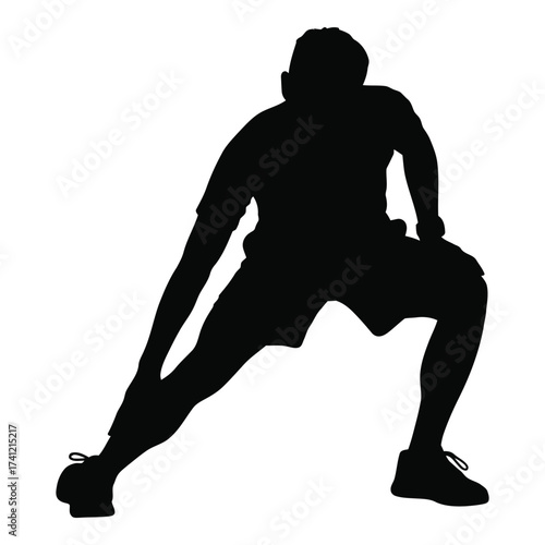 Dynamic silhouette of a man performing a strenuous leg stretch exercise for fitness and health silhouette