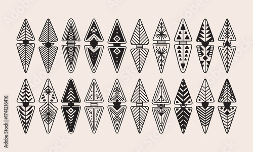 Collection of black and white tribal arrowheads with geometric patterns on a light beige background vector