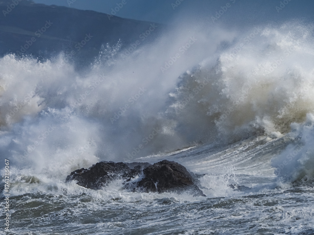 Obraz premium crashing waves over Holyhead breakwater isle of Anglesey