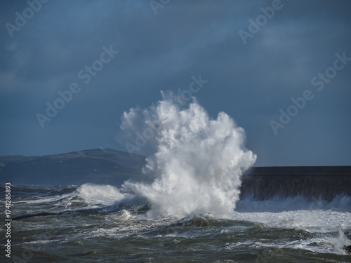 Fototapeta Naklejka Na Ścianę i Meble -  crashing waves over Holyhead breakwater isle of Anglesey