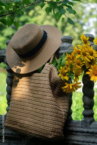 Wild flowers in a beautiful straw bag and a straw hat.