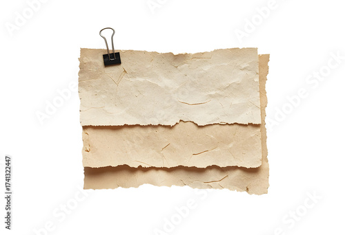 Vintage paper sheets held together by a binder clip, isolated on a white background, evoking a sense of nostalgia and historical documentkeeping