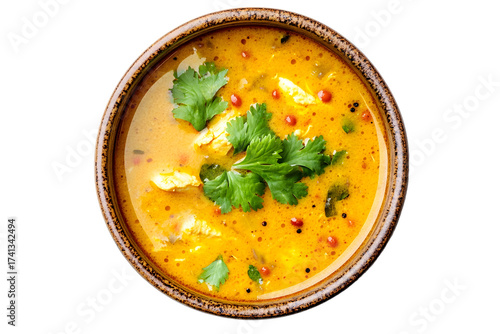 Delicious creamy soup with fresh herbs and spices in a rustic bowl
