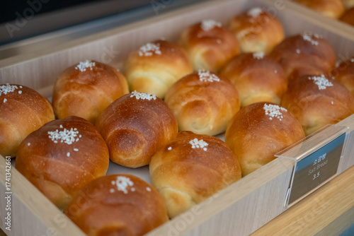 A pile of Salted bread display in the cafe, with the Korean text of Salted bread