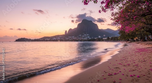 Fototapeta Naklejka Na Ścianę i Meble -  Serene Sunset Beach Scene with Mountain Backdrop and Pink Flowers