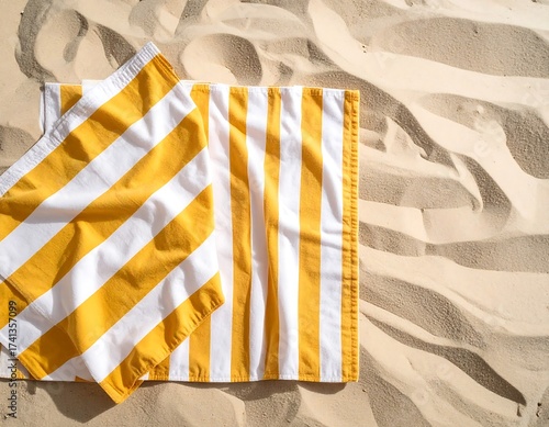 Striped beach towel on sandy beach