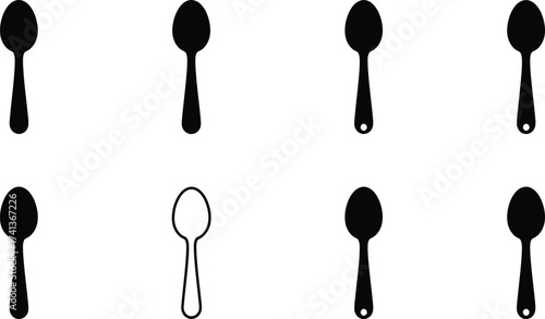 A collection of black spoons with one white spoon in view
