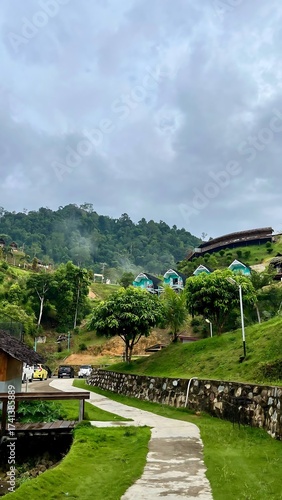 Scenic Mountain Resort with Lush Greenery and Overcast Sky.