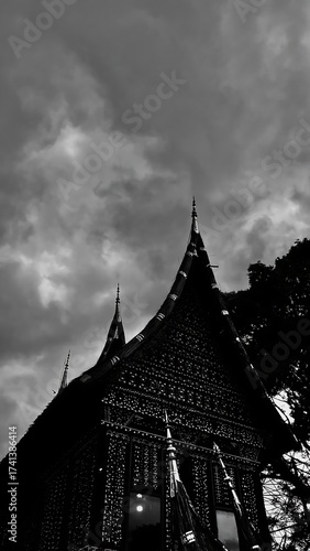 Traditional Indonesian House Silhouette Under Dramatic Cloudy Sky.