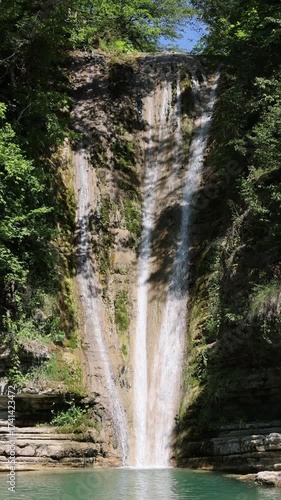8K vertical waterfall from Erfelek in Sinop, Turkey, cascading powerfully through green forest cliffs. The crystal water flow contrasts beautifully with the lush moss-covered rock
