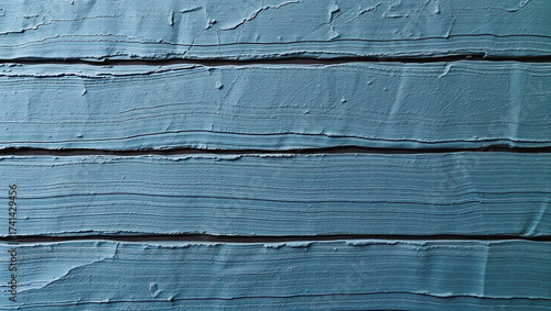 Textured blue paint on wooden surface