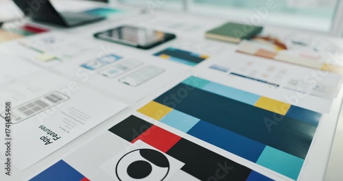 App development, documents and ux design of phone on desk in creative workplace for planning. Laptop, paperwork and tablet on table in office for digital interface or graphic model of mobile product