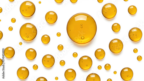 Golden translucent liquid drops, like oil or serum, on white, for beauty product ads, health packaging, cosmetic branding, or scientific visuals.