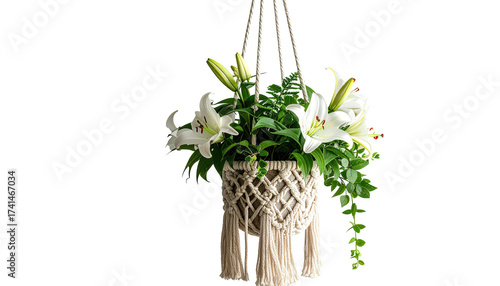 A macrame planter holding white lilies hangs
