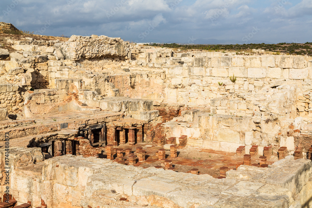 Obraz premium Ruins and remnants of ancient baths of the Sanctuary and Temple of Apollo Hylates in an ancient Greek city-state called Kourion on the island of Cyprus