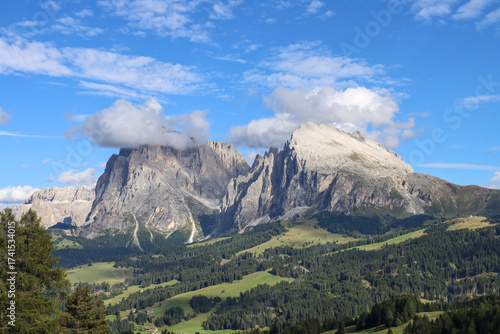 Verdant meadows of Alpe di Siusi bask in September sun, with Sassolungo towering in the distance.