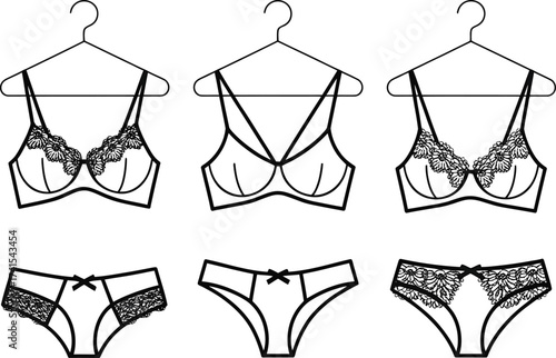 Collection of elegant lace bras and matching panties on hangers
