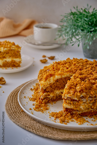 Carrot cake on a white plate on a white table