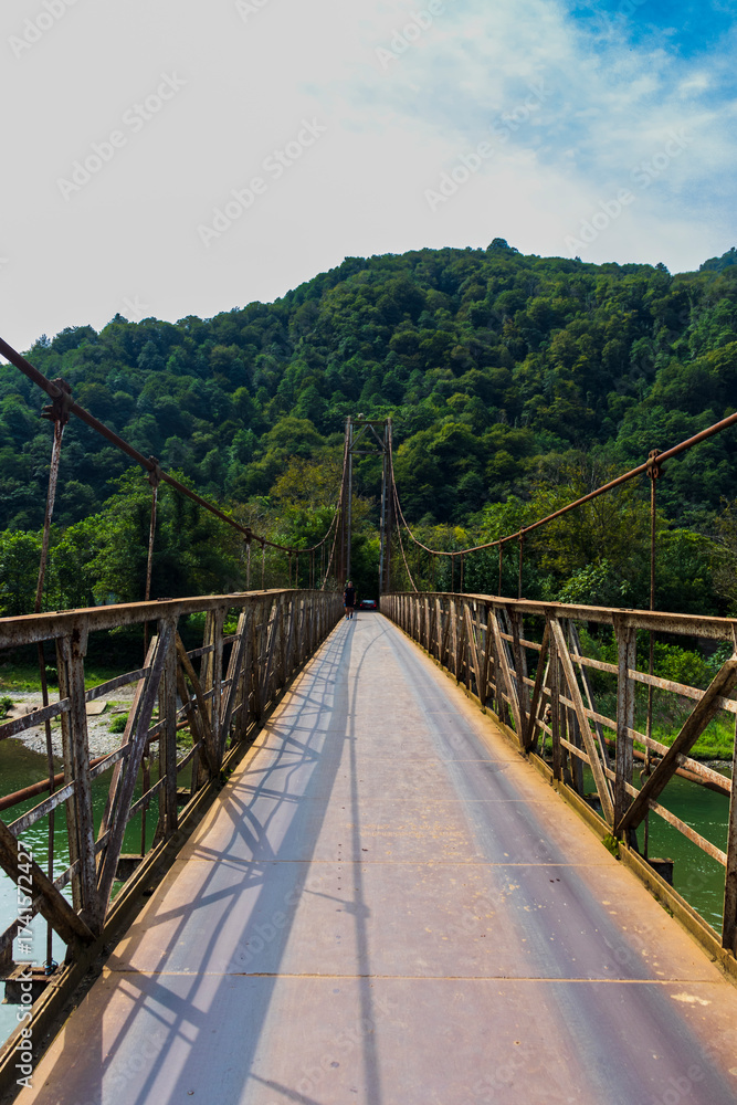 Obraz premium Shot of the suspension bridge in the mountains. Objects