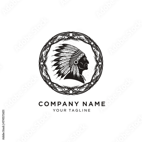 A black and white circular logo featuring the profile of a Native American chief wearing a feathered headdress, enclosed within an ornate tribal border.