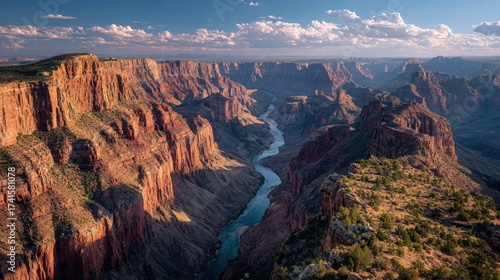 Epic landscape with a vast canyon winding river below and dramatic sunset hues hyper-detailed