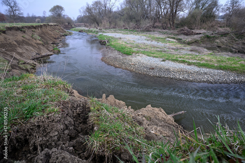 Canvas Print Riverbed with eroded bank and exposed soil.