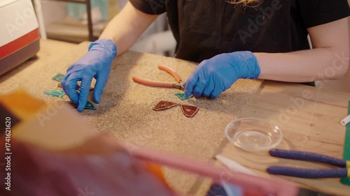 Stained glass artisan cuts colored glass, handmade art creative process