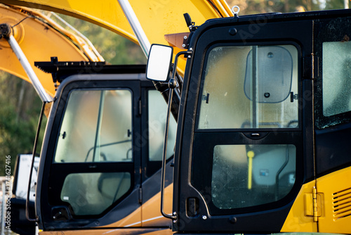 Obraz na plátně Side view of construction excavator cabs with fogged glass and visible structure