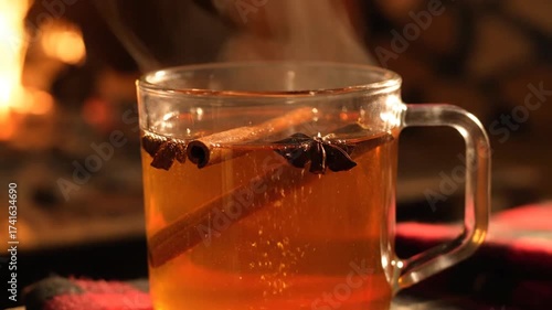Warm Spiced Beverage Near Fireplace: A Cozy Moment of Relaxation and Comfort