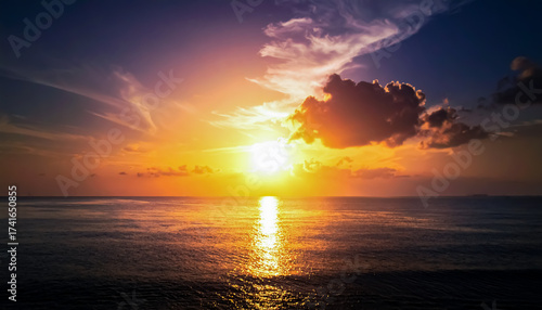 Golden Sunrise or Sunset Behind Dramatic Clouds over the Ocean with Intense Reflections