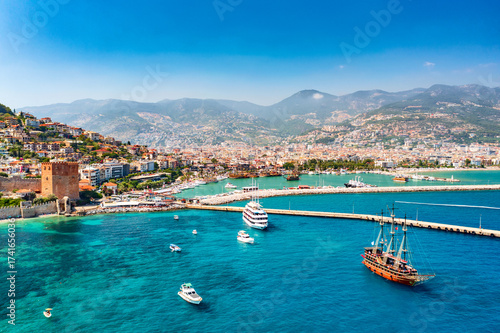 Fototapeta Naklejka Na Ścianę i Meble -  Aerial drone view of beautiful harbor with ships and boats and Kizil Kule Red tower in Alanya, Turkey. Summer sunny day