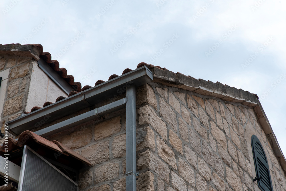 Fototapeta premium Metal square gutter and downpipe on eaves