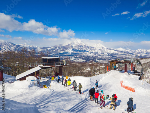 People queuing for a ski lift with a stunning view of Mount Myoko (Madarao, Nagano, Japan)