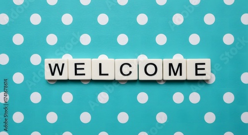 WELCOME Word Spelled Out with Scrabble Tiles on a Teal Polka Dot Background