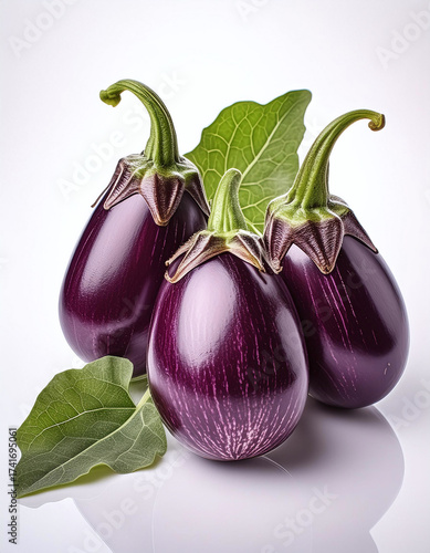 Wallpaper Mural Three glossy eggplants with vibrant green leaves on a white background. Generative AI. Torontodigital.ca