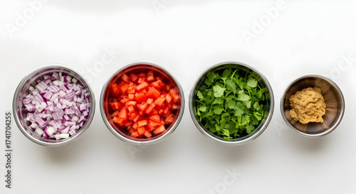 Four Metal Bowls Filled with Diced Red Onion, Tomatoes, Cilantro, and Garlic Paste