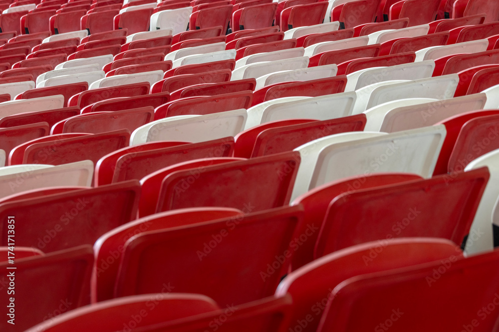 Naklejka premium Red and white seating arrangement inside a giant stadium.