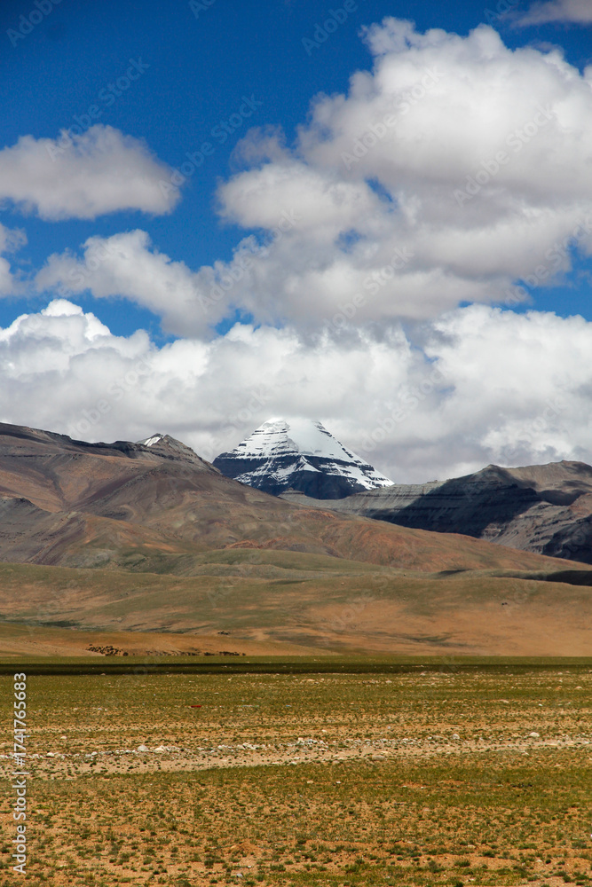 Fototapeta premium Majestic snow - capped mountain under blue sky with clouds