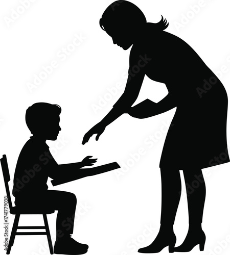 Teacher helping student at desk child chair