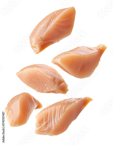 Raw chicken breast pieces scattered fresh protein food ingredient isolated studio shot