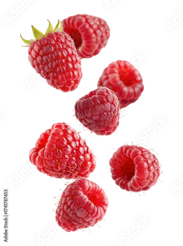 Fresh ripe raspberries falling in mid-air capturing delicious organic fruit in motion